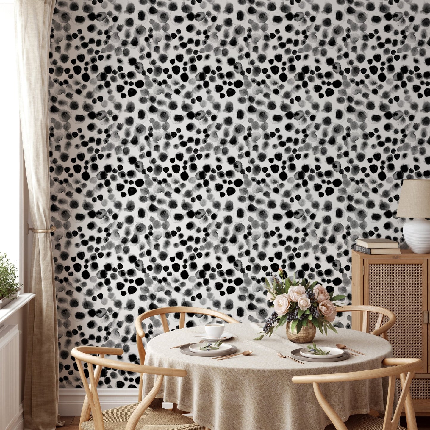 Watercolor geometric wallpaper in a dining space with light wood furniture.