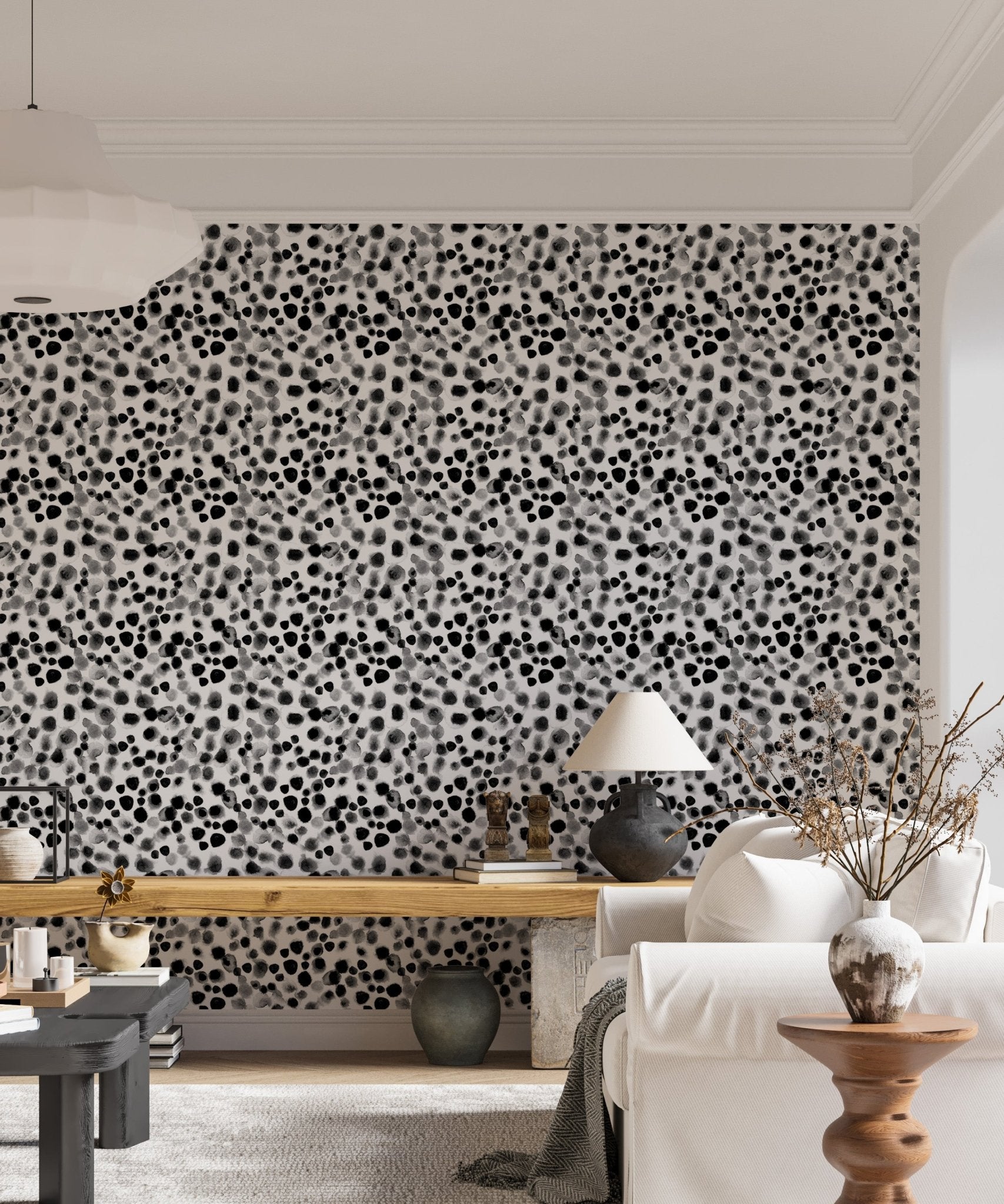 Scattered ink dot wallpaper behind a white sofa and indoor plants.