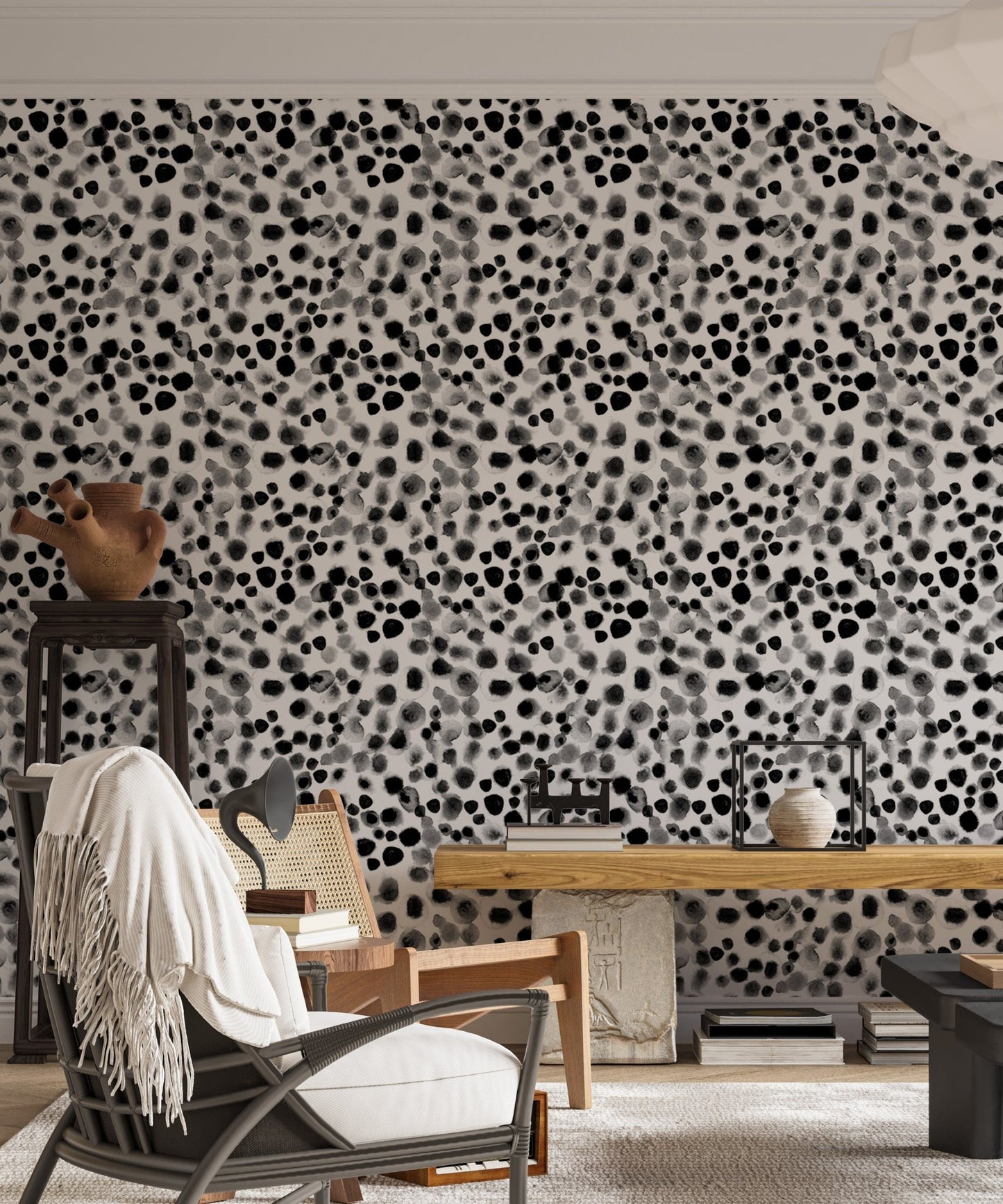 Monochrome scattered dot wallpaper in a minimalist living area with a black chair.