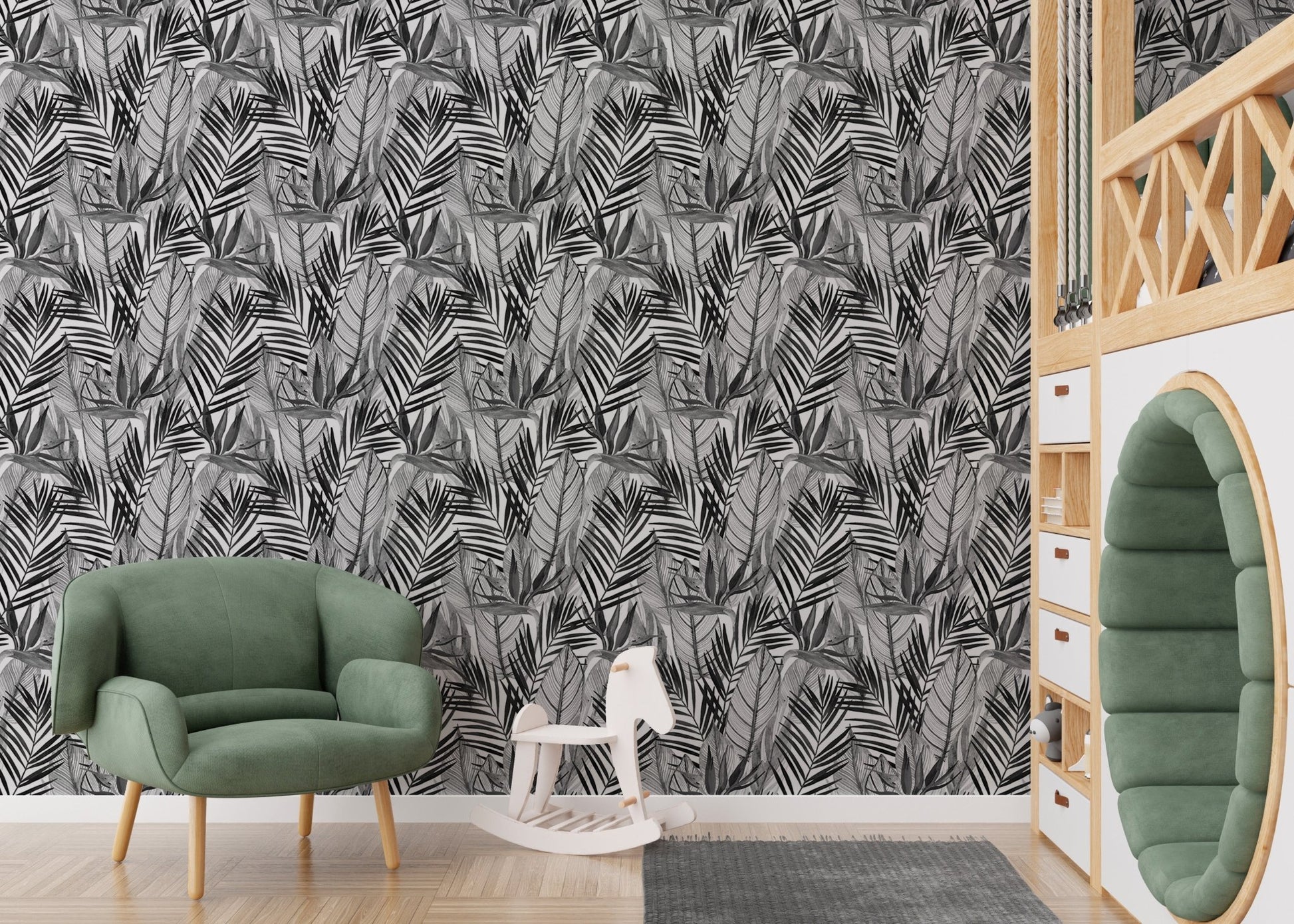 Palm leaf wallpaper in kids playroom with green armchair and white toys.