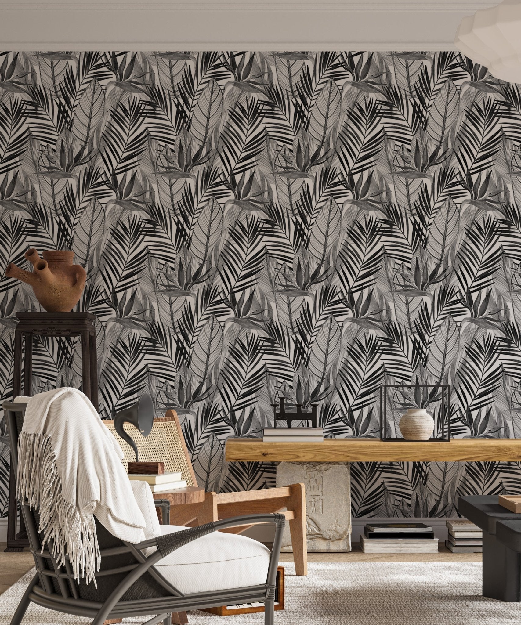 Watercolor tropical wallpaper in living area with armchair and wooden furniture.