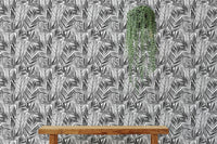 Monochrome botanical palm wallpaper behind a wooden bench with hanging greenery.