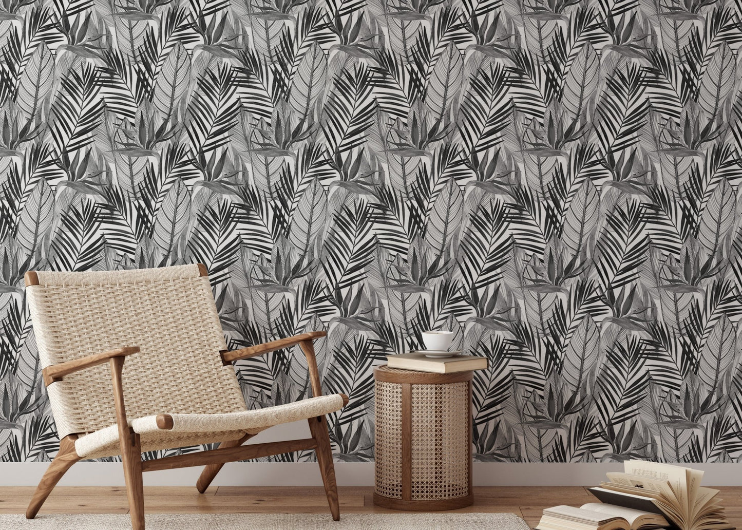 Black and white botanical wallpaper behind light wood chair and side table.