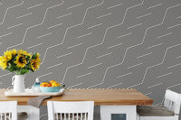 Black and white zigzag geometric stripes wallpaper in a dining area with sunflowers.