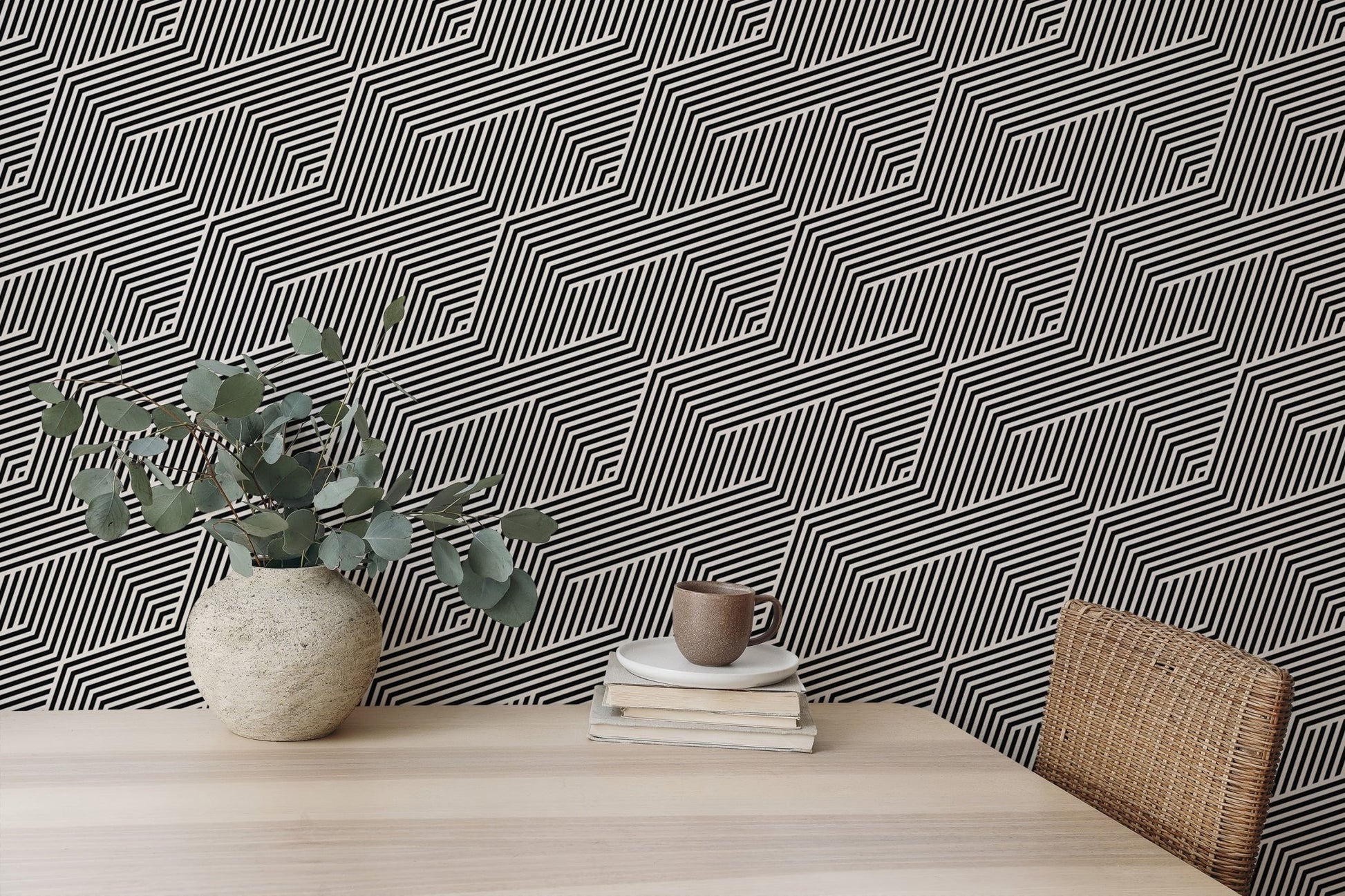 Black and white zigzag geometric stripes wallpaper in a bright workspace.