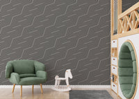 Contemporary zigzag wallpaper in a playroom with a green velvet chair.