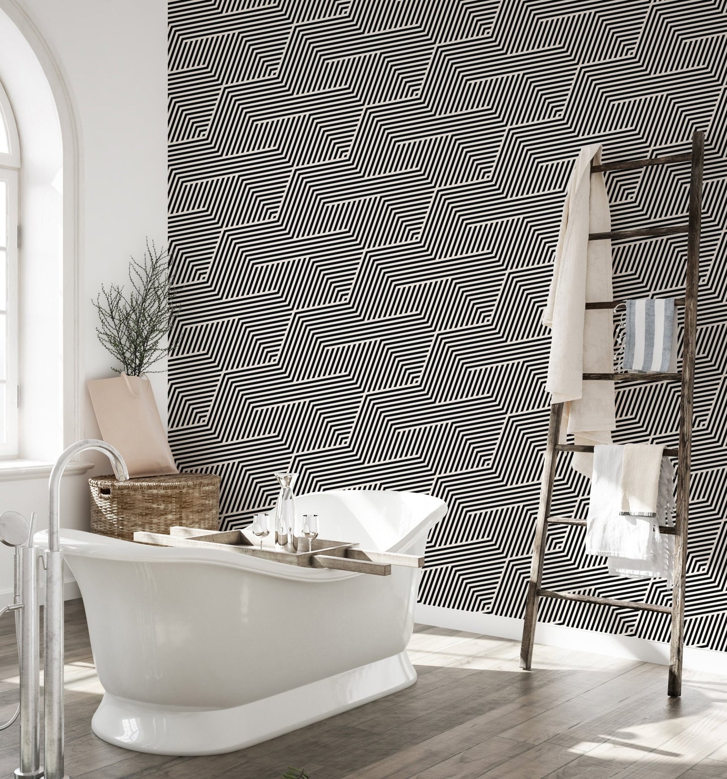 Geometric stripes wallpaper in a bathroom with a white freestanding tub.