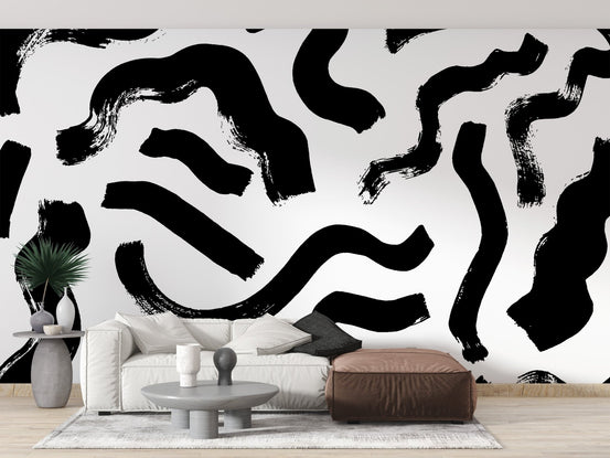 Black brushstrokes abstract wall mural with bold ink swirls on white.