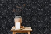 Textured floral damask wallpaper on a wooden stool with a ceramic vase.