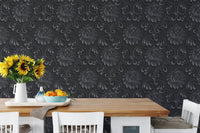 Floral pattern wallpaper in a dining area behind a wooden table with sunflowers.