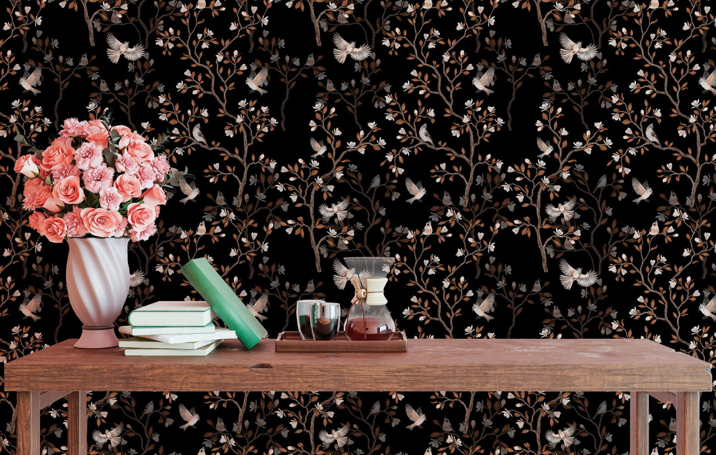 Study area wall decorated with black bird and branch wallpaper and a wooden table.