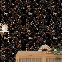Black background wallpaper featuring brown magnolia branches behind a wooden cabinet.