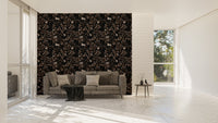 Dark tree wallpaper in a large living area with a grey sofa and natural light.