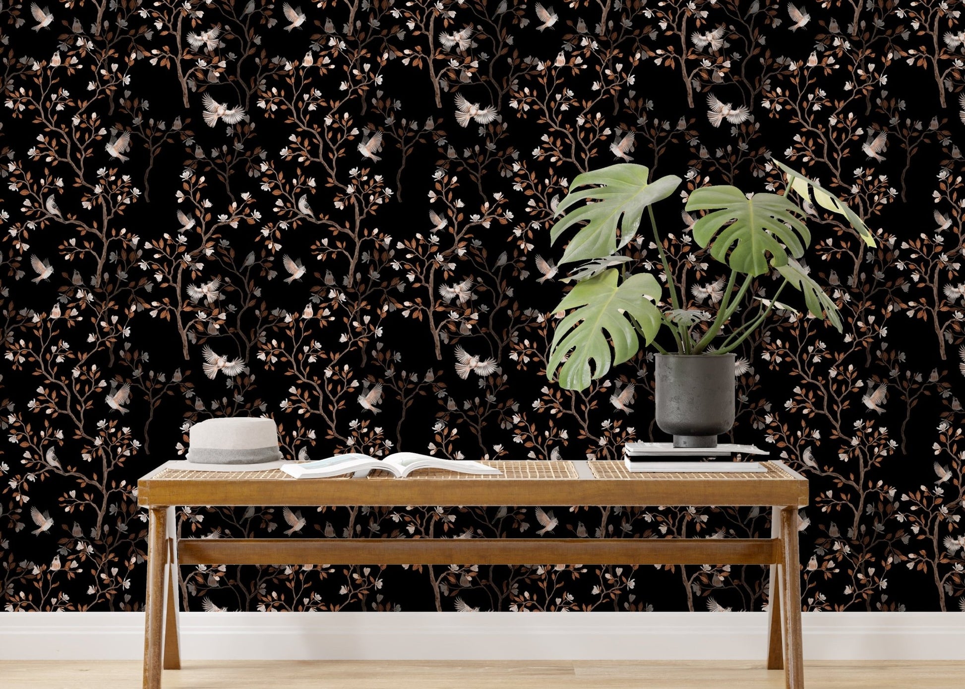 Black Color Chinoiserie Repeat Pattern Magnolia Tree Birds Wallpaper behind a wooden bench.