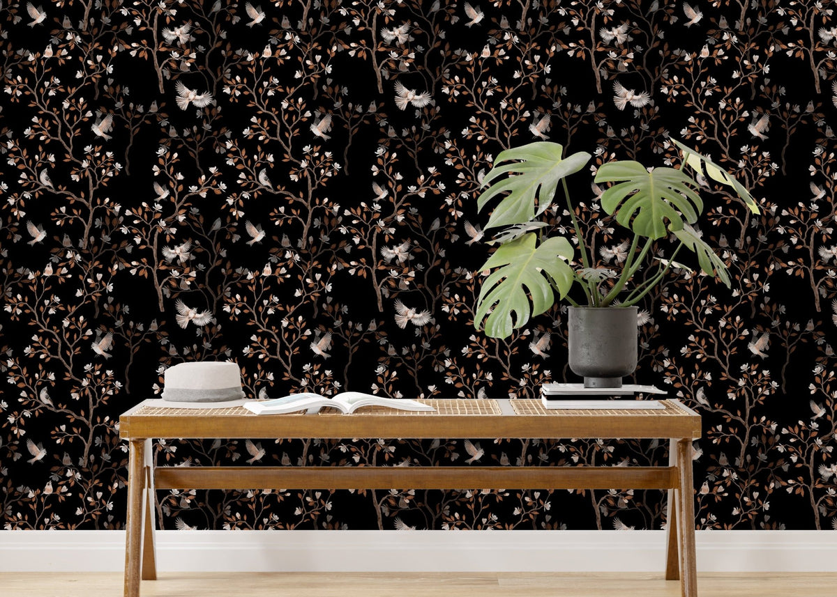 Black Color Chinoiserie Repeat Pattern Magnolia Tree Birds Wallpaper behind a wooden bench.