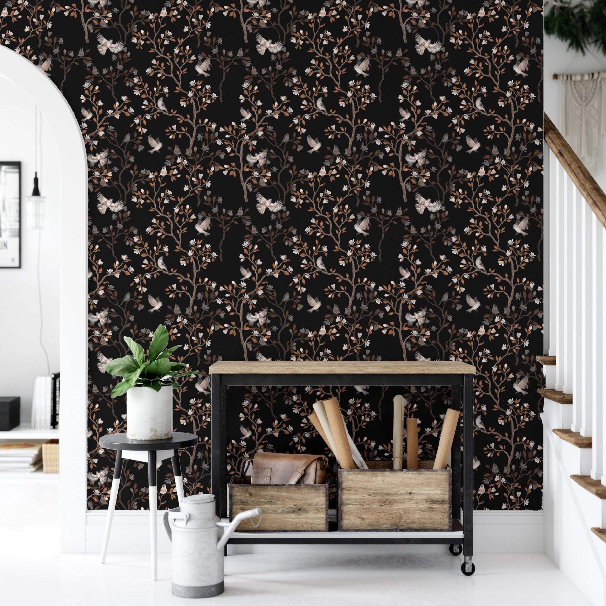 Chinoiserie bird and tree wallpaper in a hallway with a black metal shelf unit.