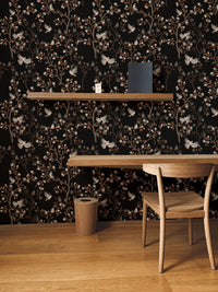 Study room wallpaper with black botanical patterns and a wooden floating desk.