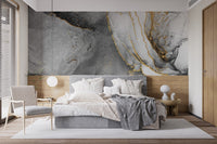 Abstract ink fusion mural with striking black and gold accents in bedroom.
