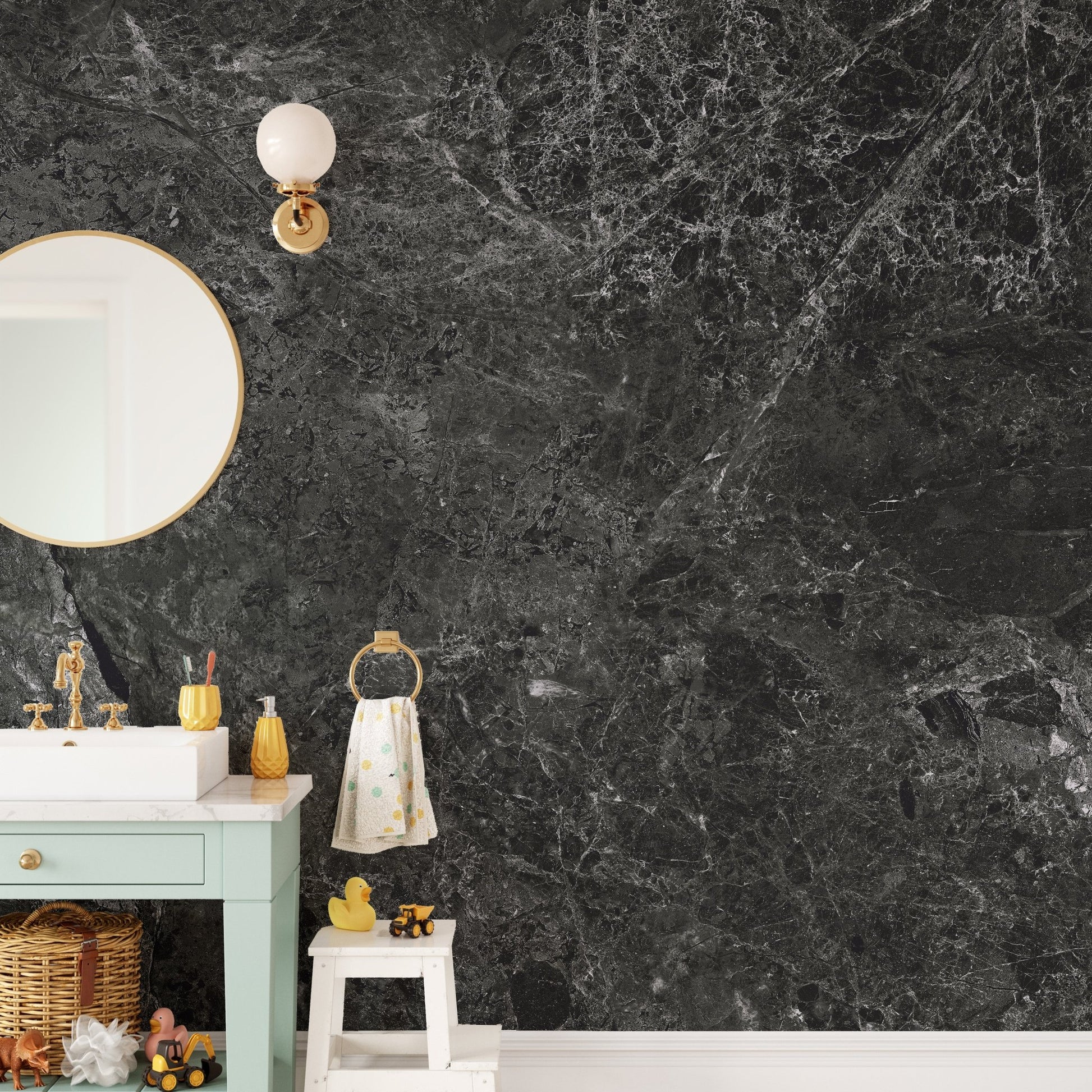 Vanity area with a dark stone wallpaper mural and circular mirror.
