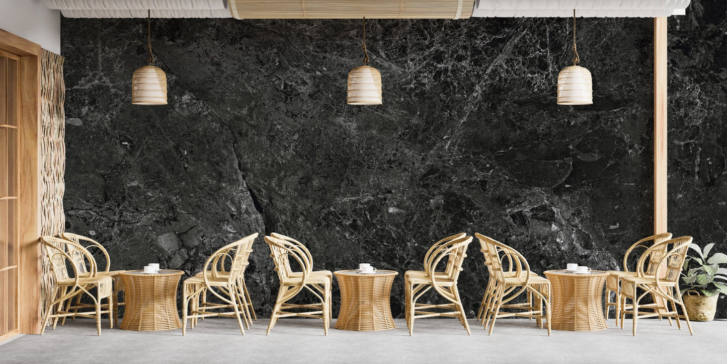 Spacious cafe interior decorated with black stone effect wallpaper mural.