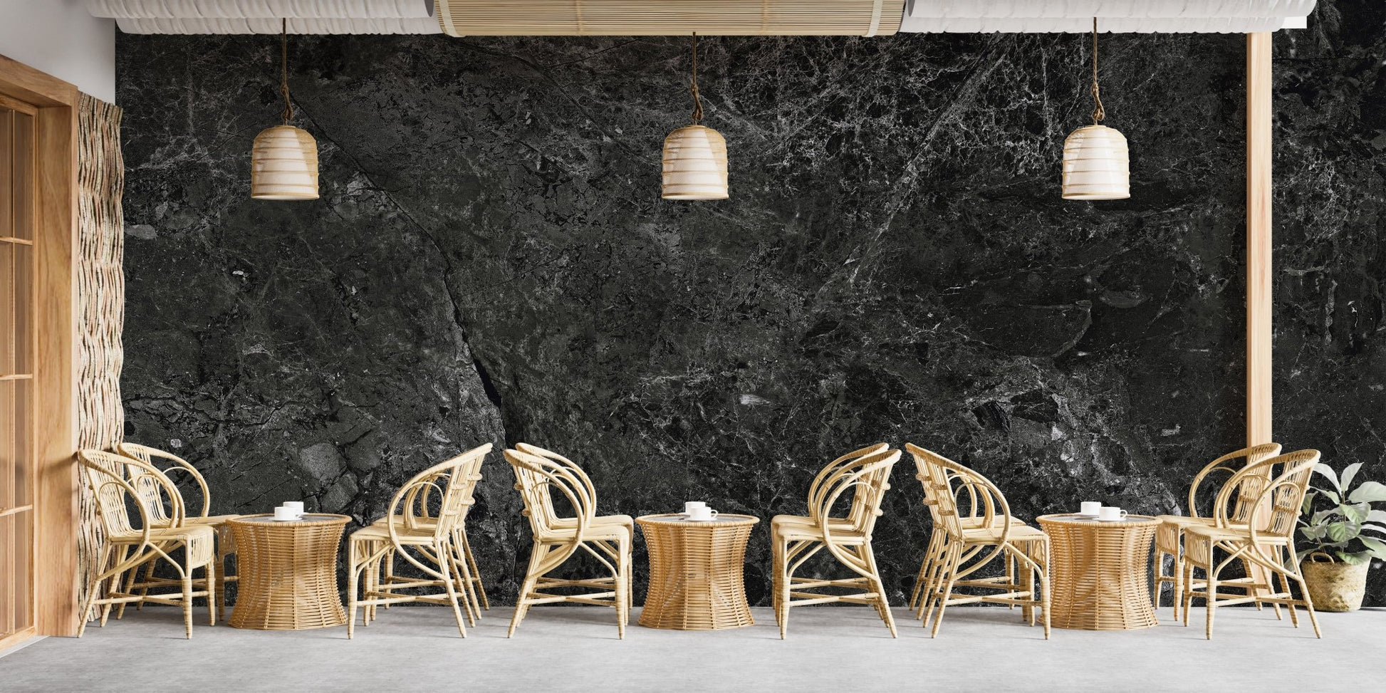 Spacious cafe interior decorated with black stone effect wallpaper mural.