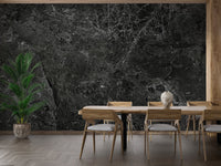 Large dining area showing a dark granite style wall mural with wooden furniture.