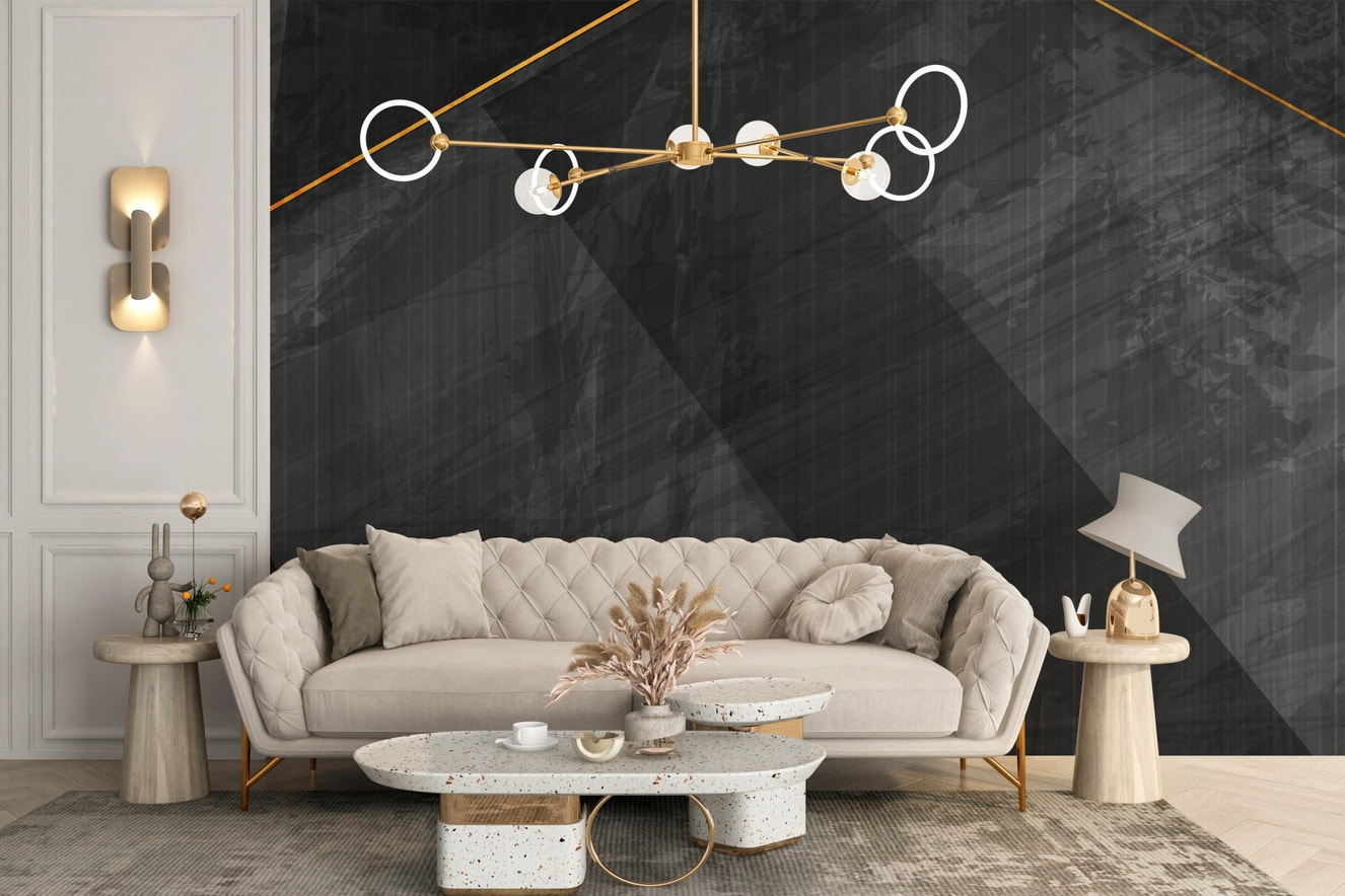 Living room with a white sofa and black marble wall mural with gold lines.