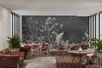Dark jungle theme mural with white peacock and floral details in cafe area.