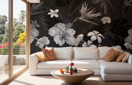 Black and white floral wall mural behind a white sofa in a sunlit living room.