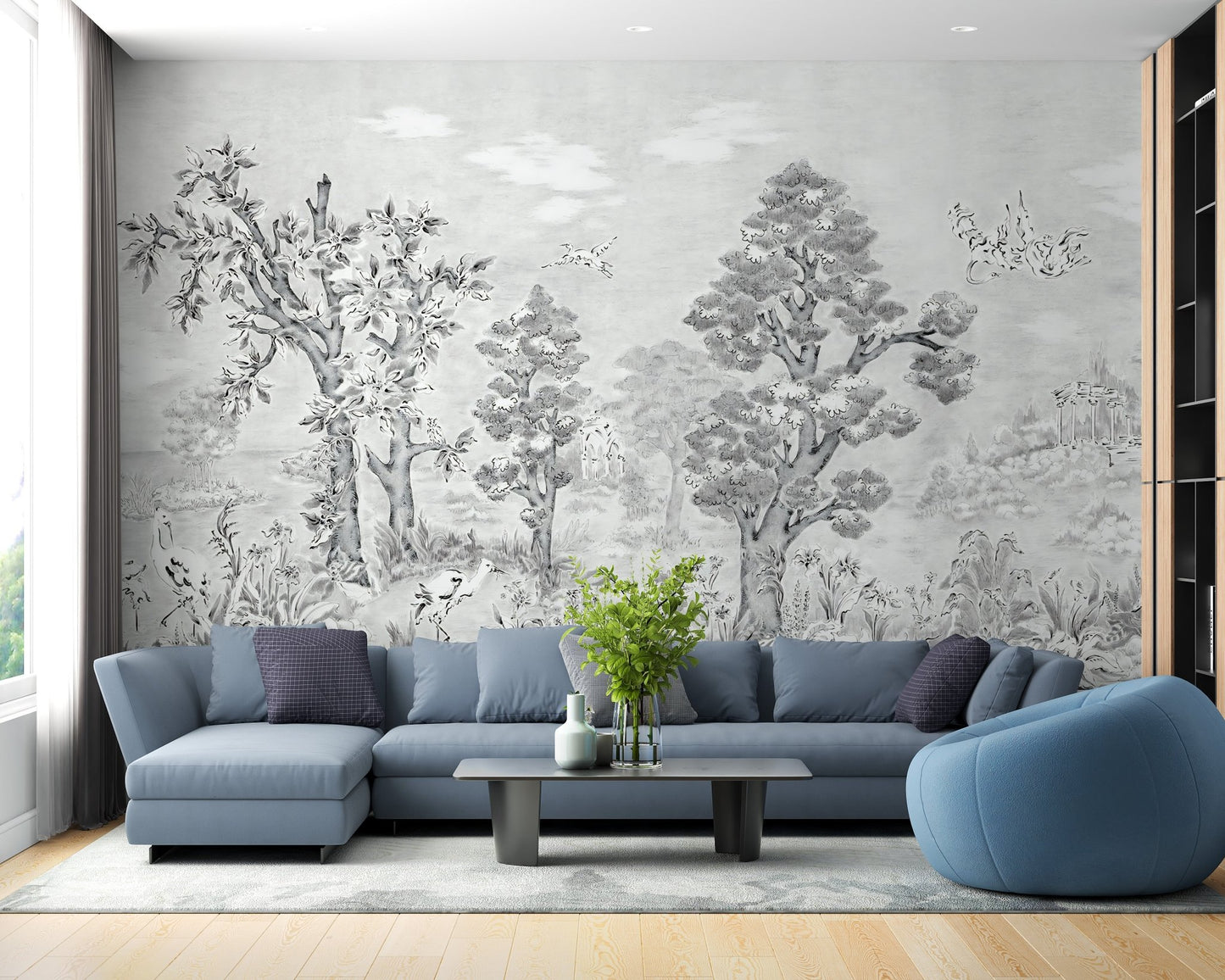 Large scale tropical forest wall mural in a living space with a blue sectional.