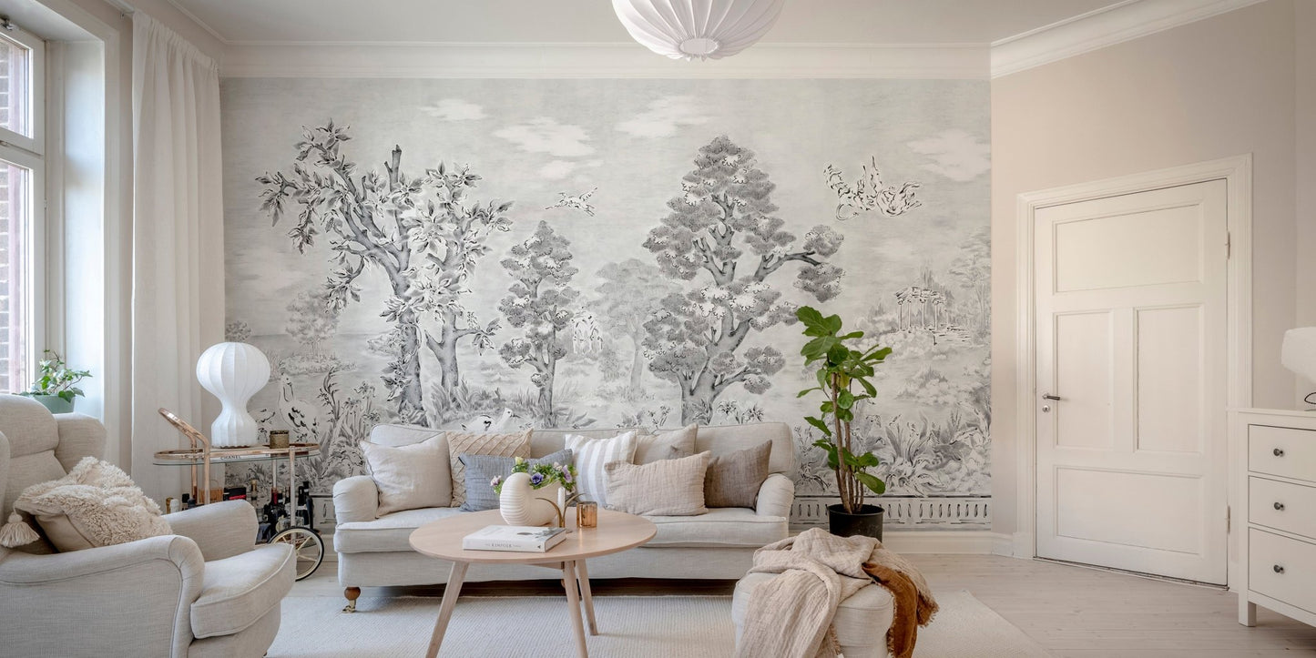 Monochrome tree wall mural behind a beige sofa in a contemporary living room.
