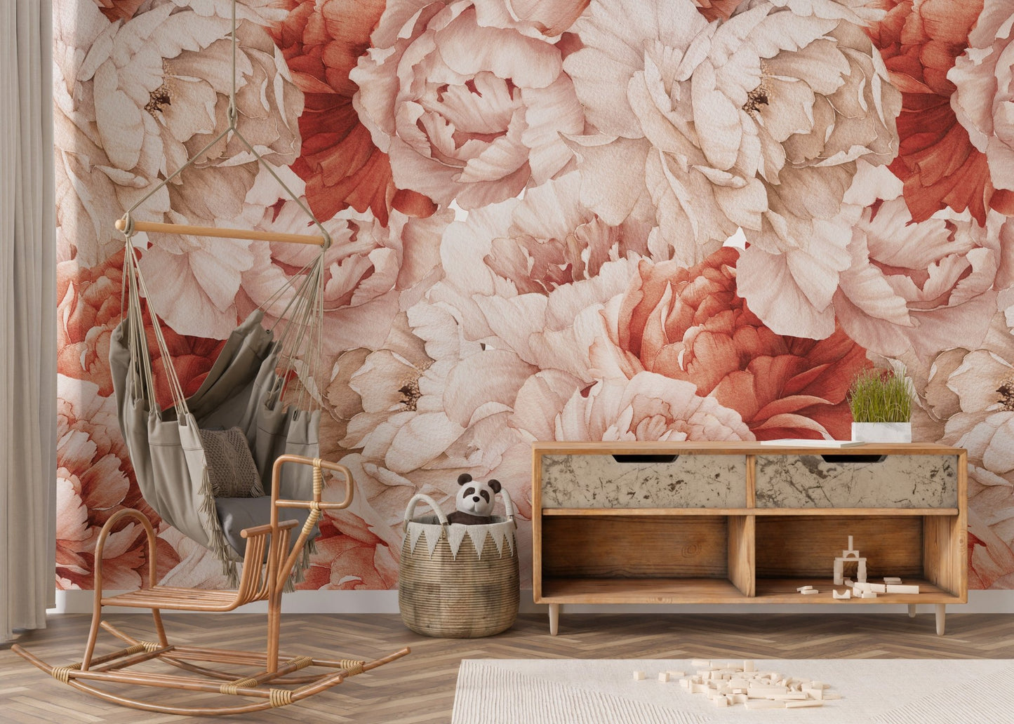 Pink and orange floral wall mural behind a wooden sideboard and hanging chair.