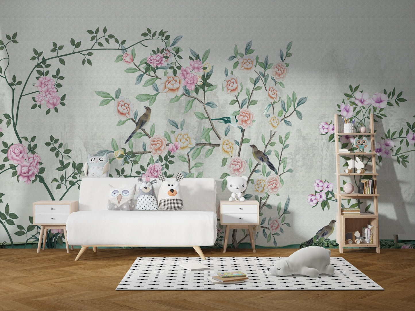White sofa placed against a light grey floral trail wall mural in kids room.