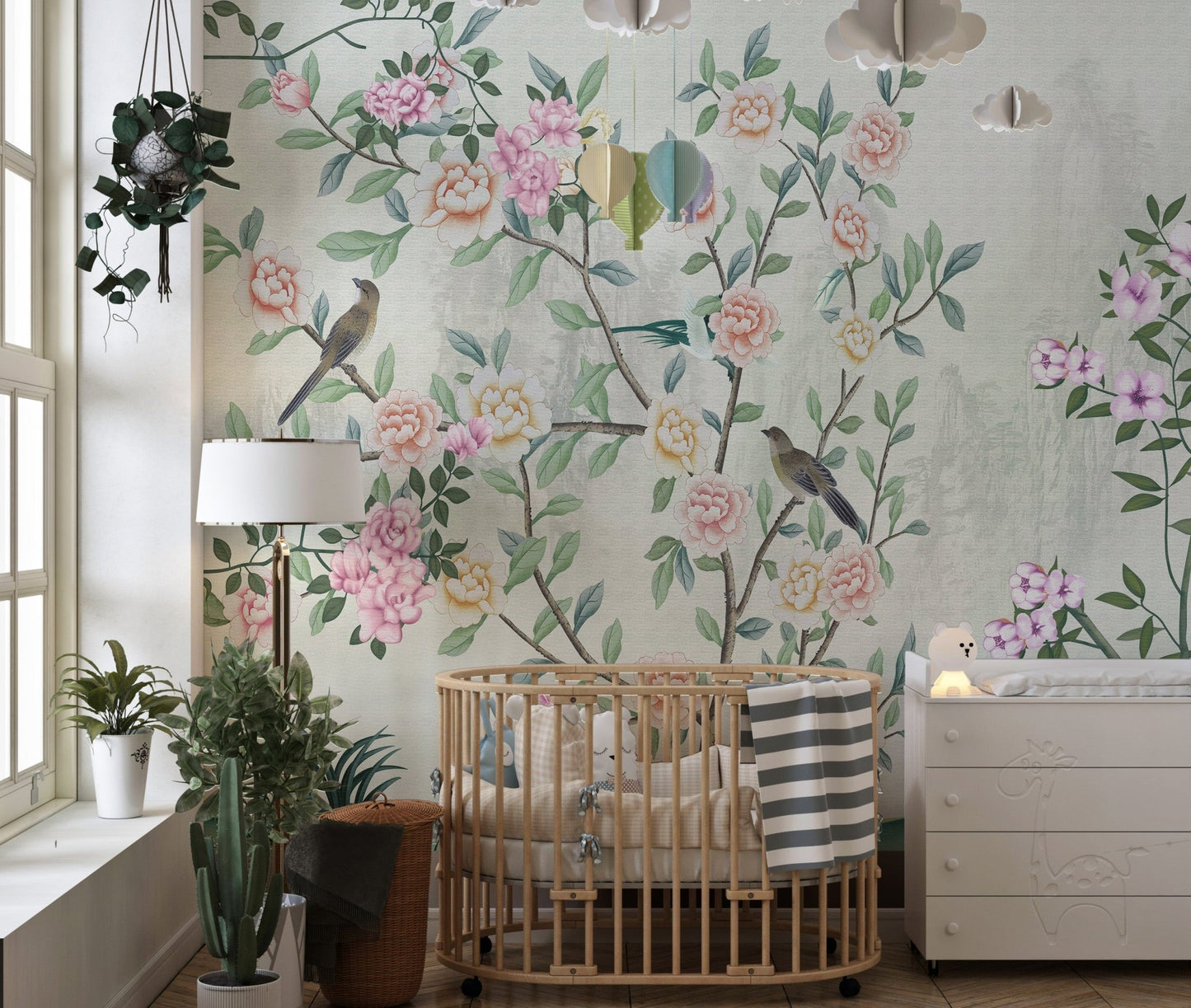 Nursery room with a wooden crib and floral garden design wall mural.