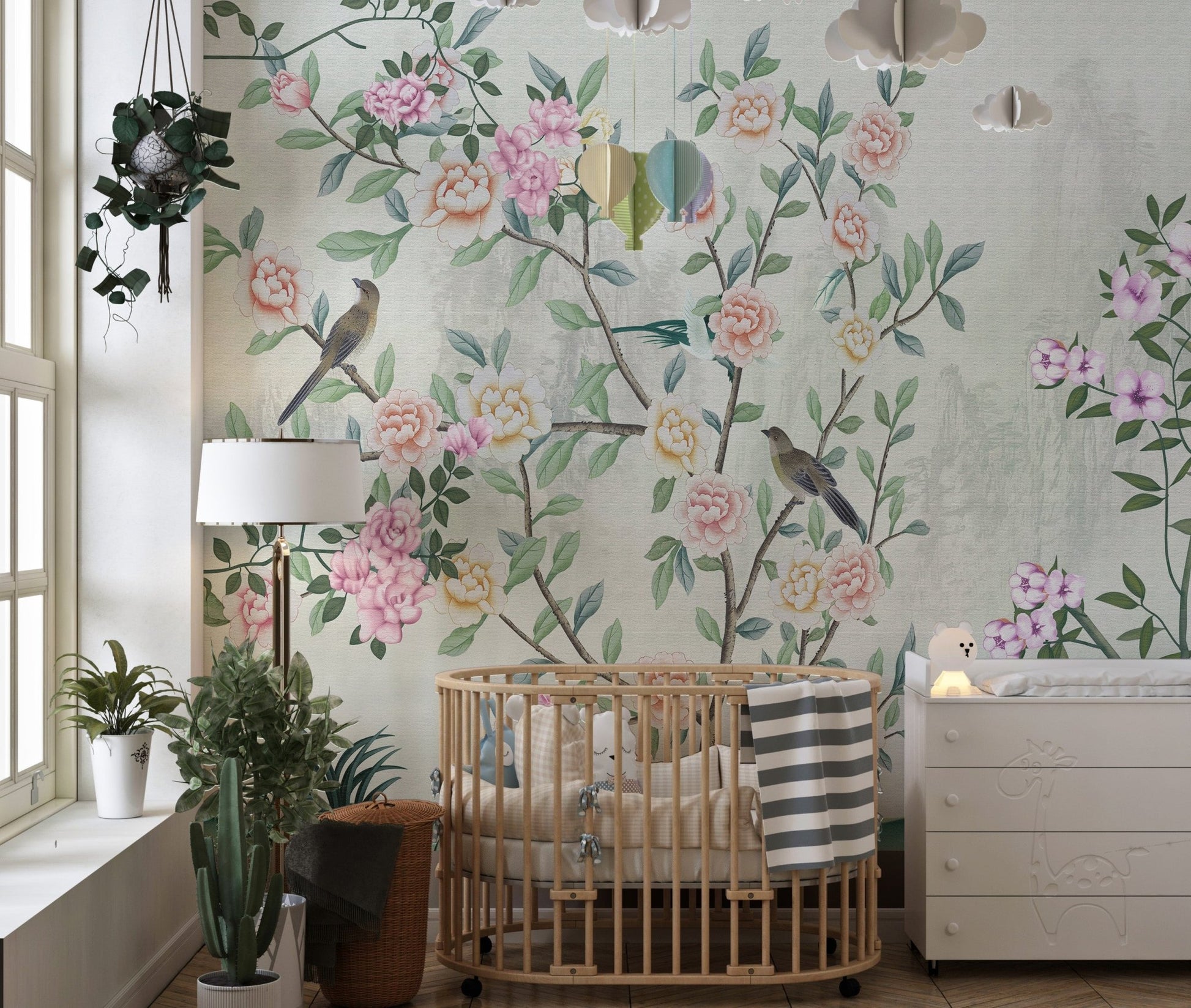 Nursery room with a wooden crib and floral garden design wall mural.