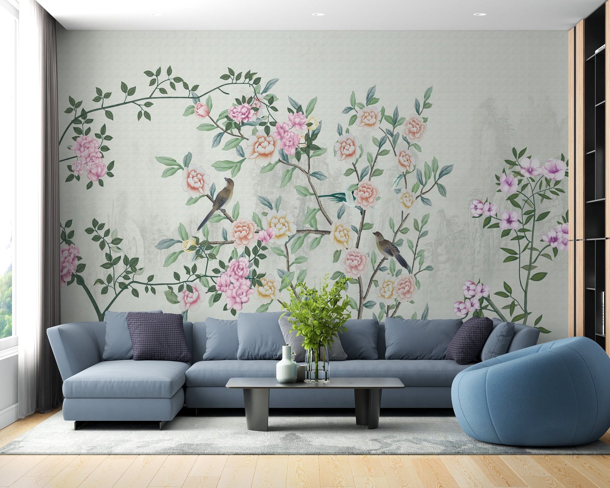 Large blue sofa paired with a vintage style floral garden wall mural.