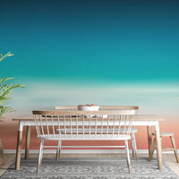 Minimalist dining space with a white table and Blurred Sea Ombre Mural.