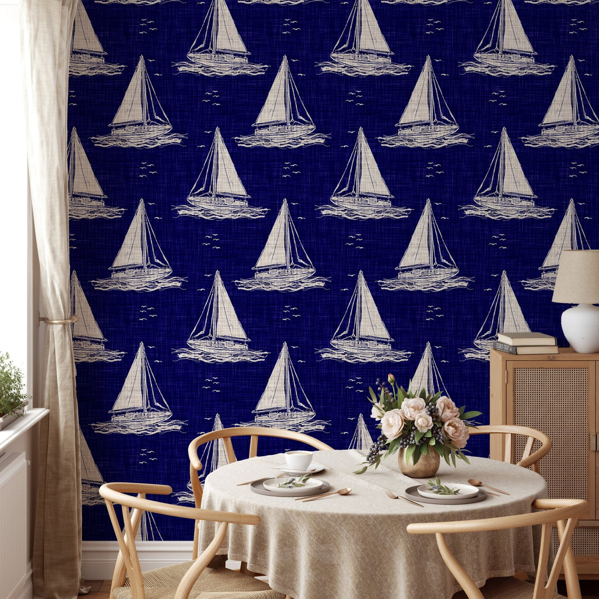 Nautical navy blue wallpaper with white ship motifs in a dining room setting.