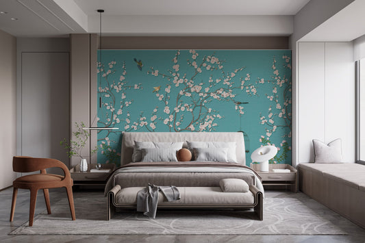 Modern bedroom with blue background pink flower wall mural behind a king bed.