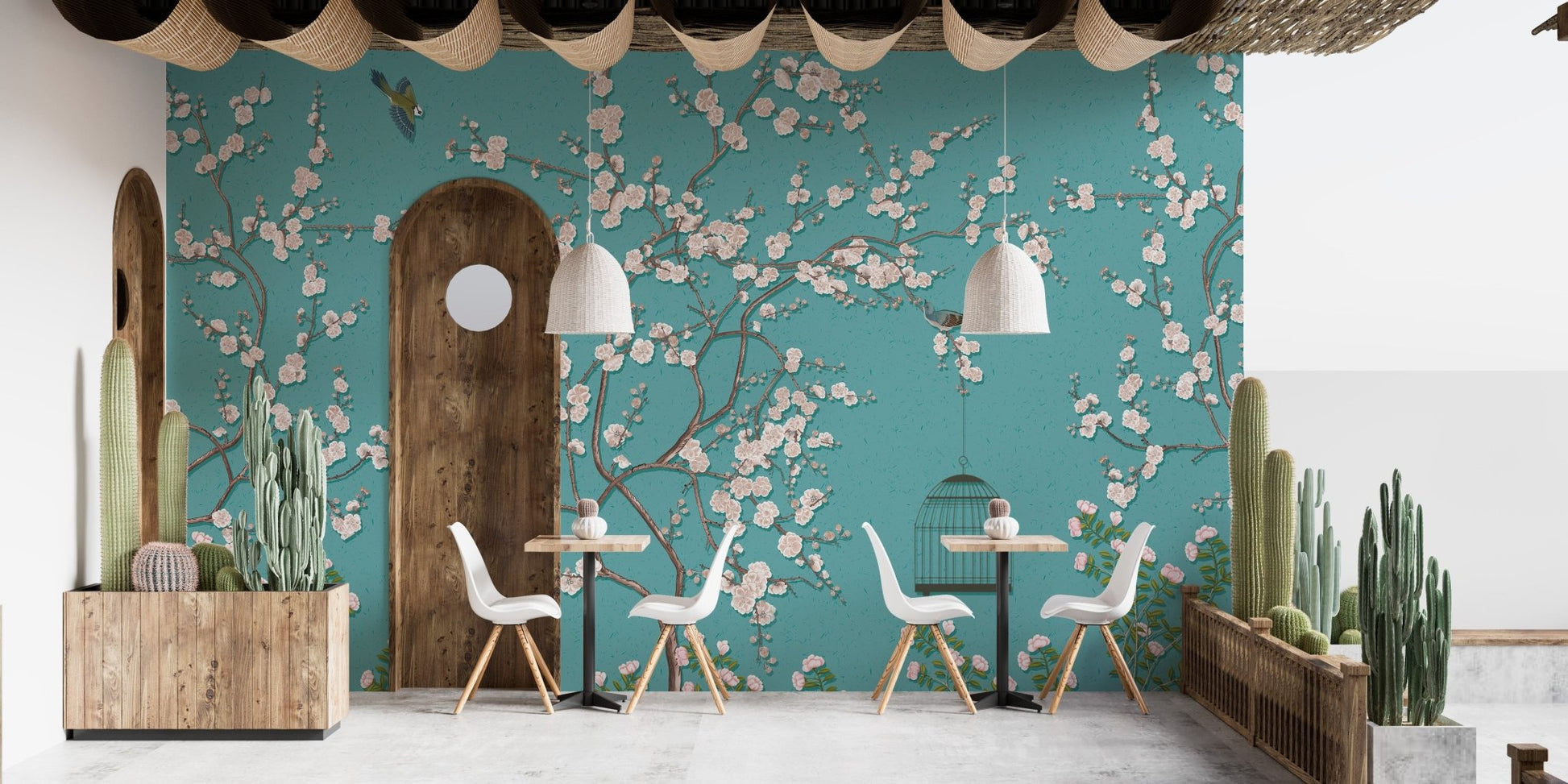 Cafe interior with teal flower wall mural and wooden dining furniture.