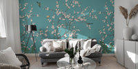 Contemporary sitting room with teal flower wall mural and a dark accent chair.