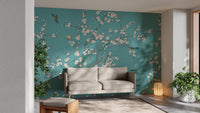 Minimalist living room featuring teal flower wall mural and a grey sofa.