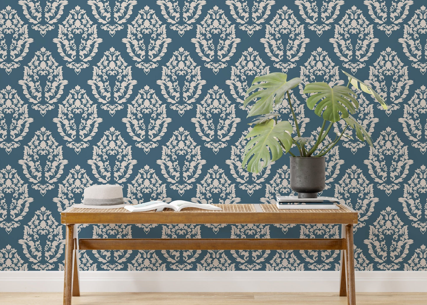 Blue Baroque wallpaper styled with indoor plants and wooden furniture.