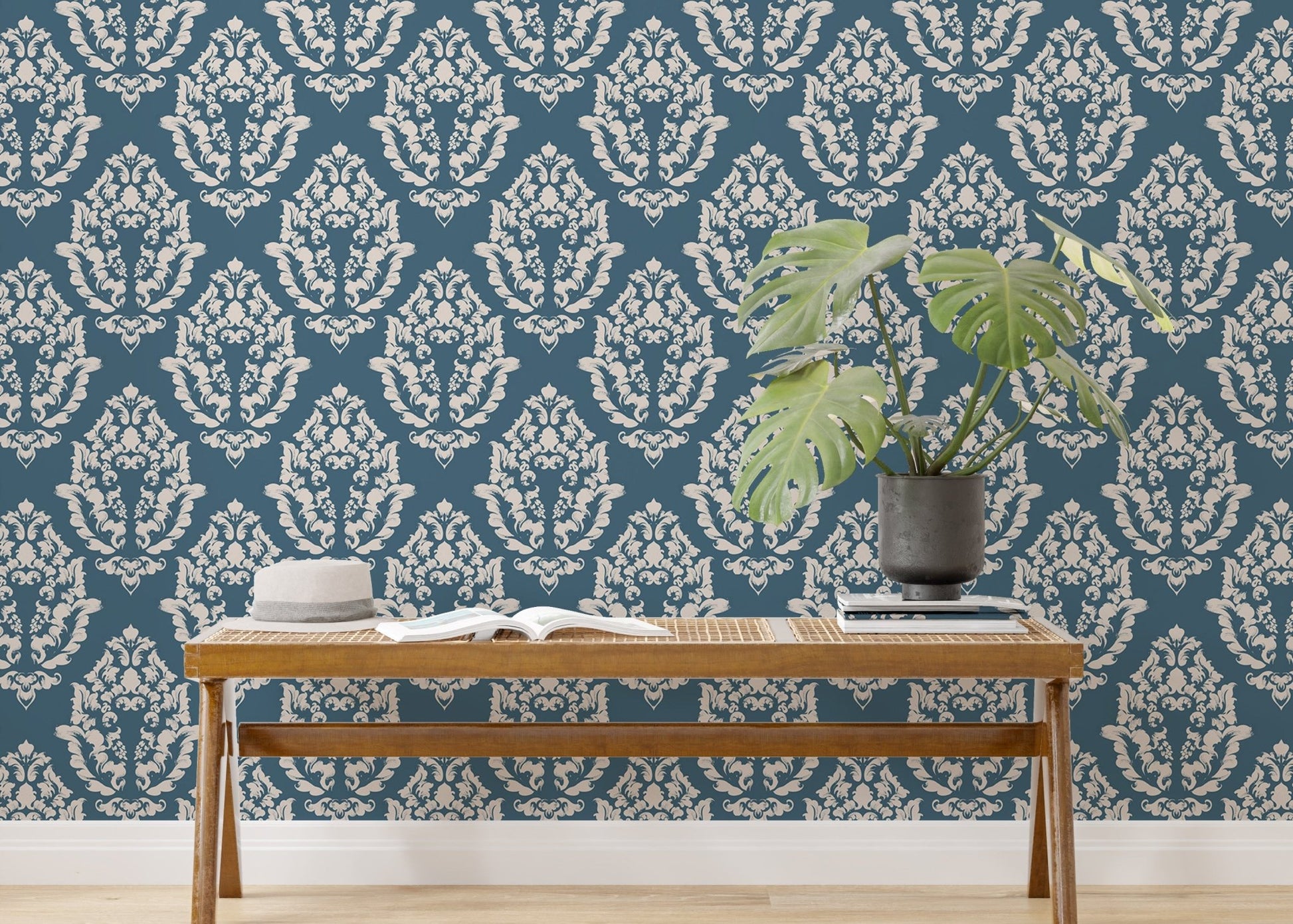 Blue Baroque wallpaper styled with indoor plants and wooden furniture.