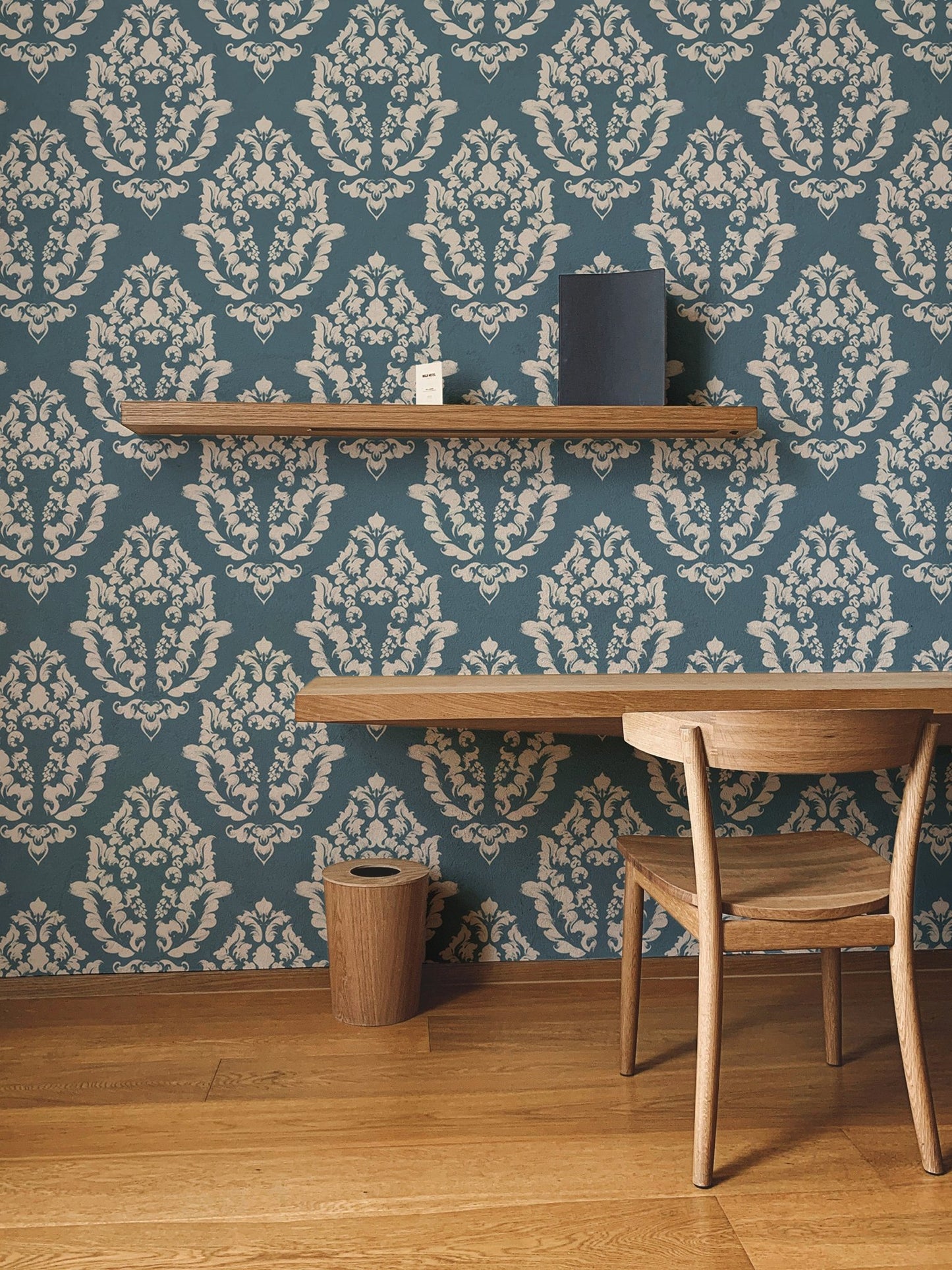 Intricate Baroque wallpaper displayed in a minimalist study area.