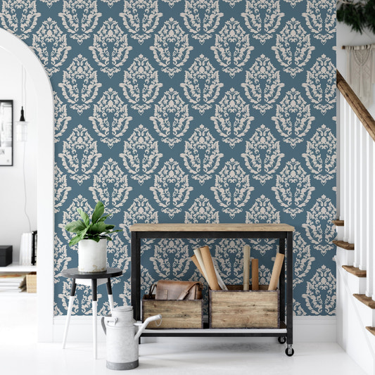 Blue Baroque wallpaper behind a wooden console table in a hallway.
