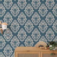 Damask wallpaper pattern in a home with a wooden desk and shelf.