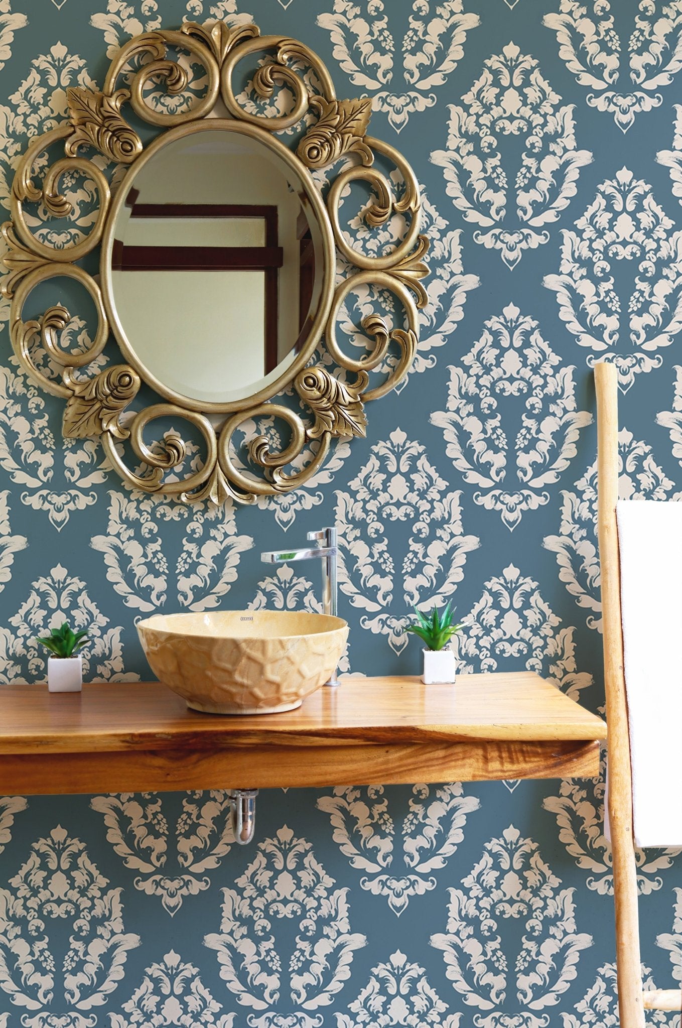 Textured blue pattern wallpaper in a bathroom with a round mirror.