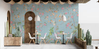 Cafe seating area featuring floral elegance wall mural and wooden accents.