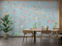 Blue Floral wall mural behind a wooden dining table and matching chairs.
